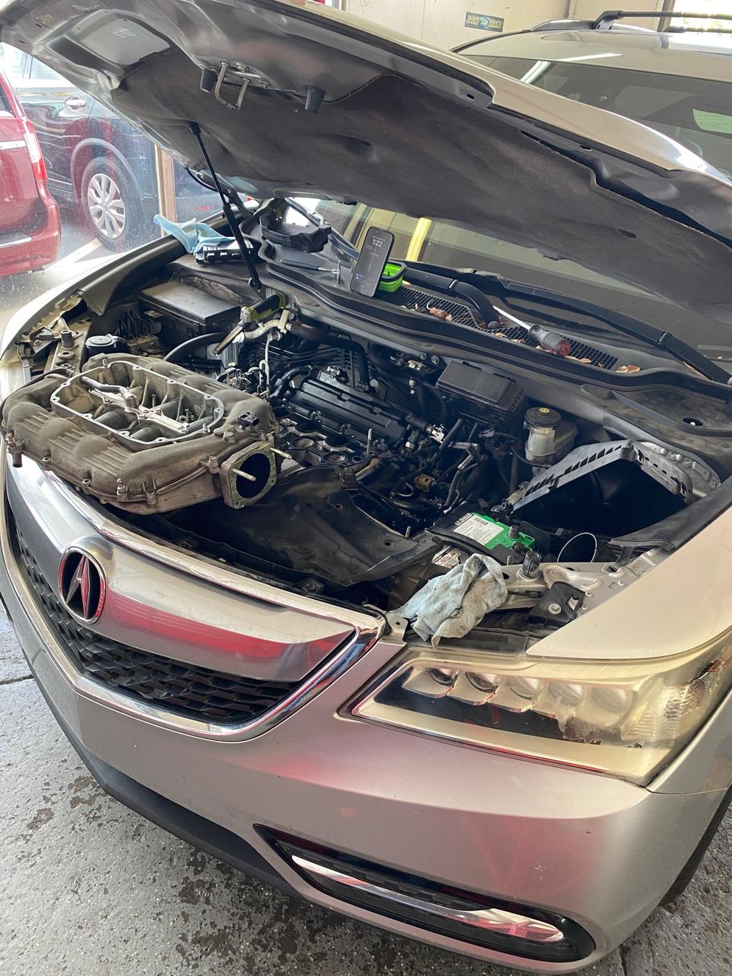 Acura engine bay with intake manifold removed during repair