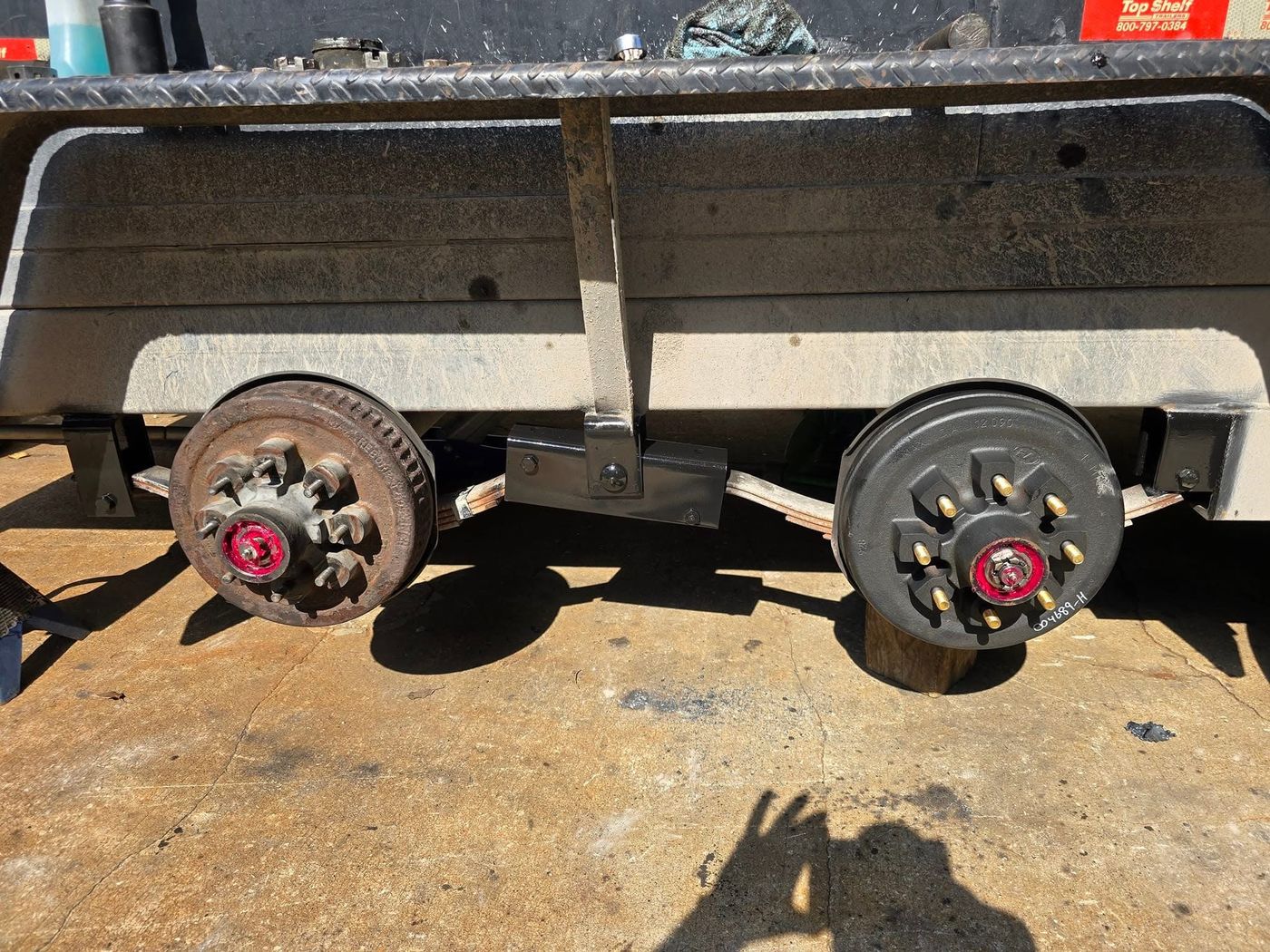Trailer axle with new brake drums and hardware