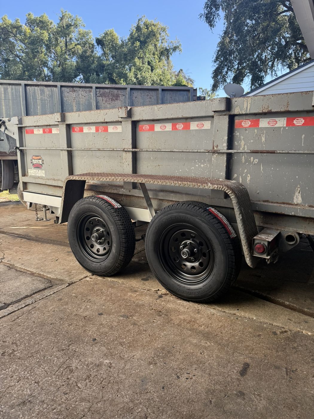 Dump trailer with new tires on black wheels